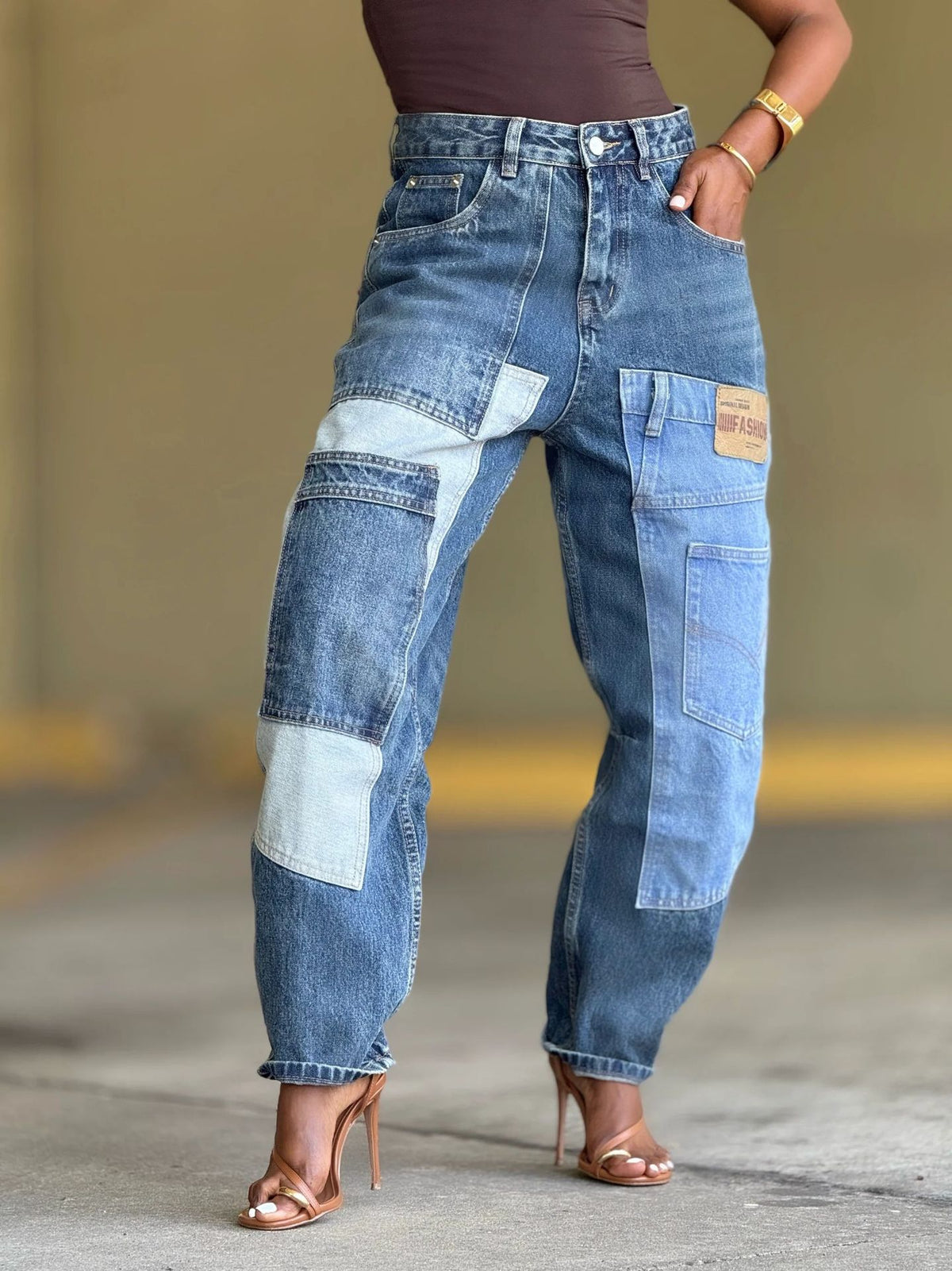 Deconstructed patchwork multi-pocket tapered denim jeans from Plush Fashion Hub with unique design and distressed details.