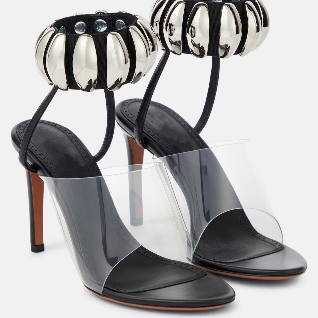 eprolo clear buckle open-toe stilettos heels featuring a transparent strap and sleek stiletto heel design.