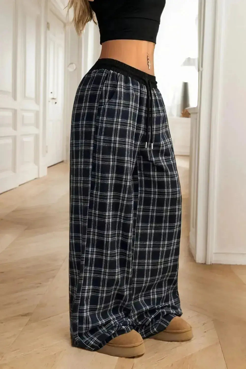 Women’s high-waisted flannel plaid wide-leg trousers from Plush Fashion Hub, featuring a cozy, stylish design with a relaxed fit.