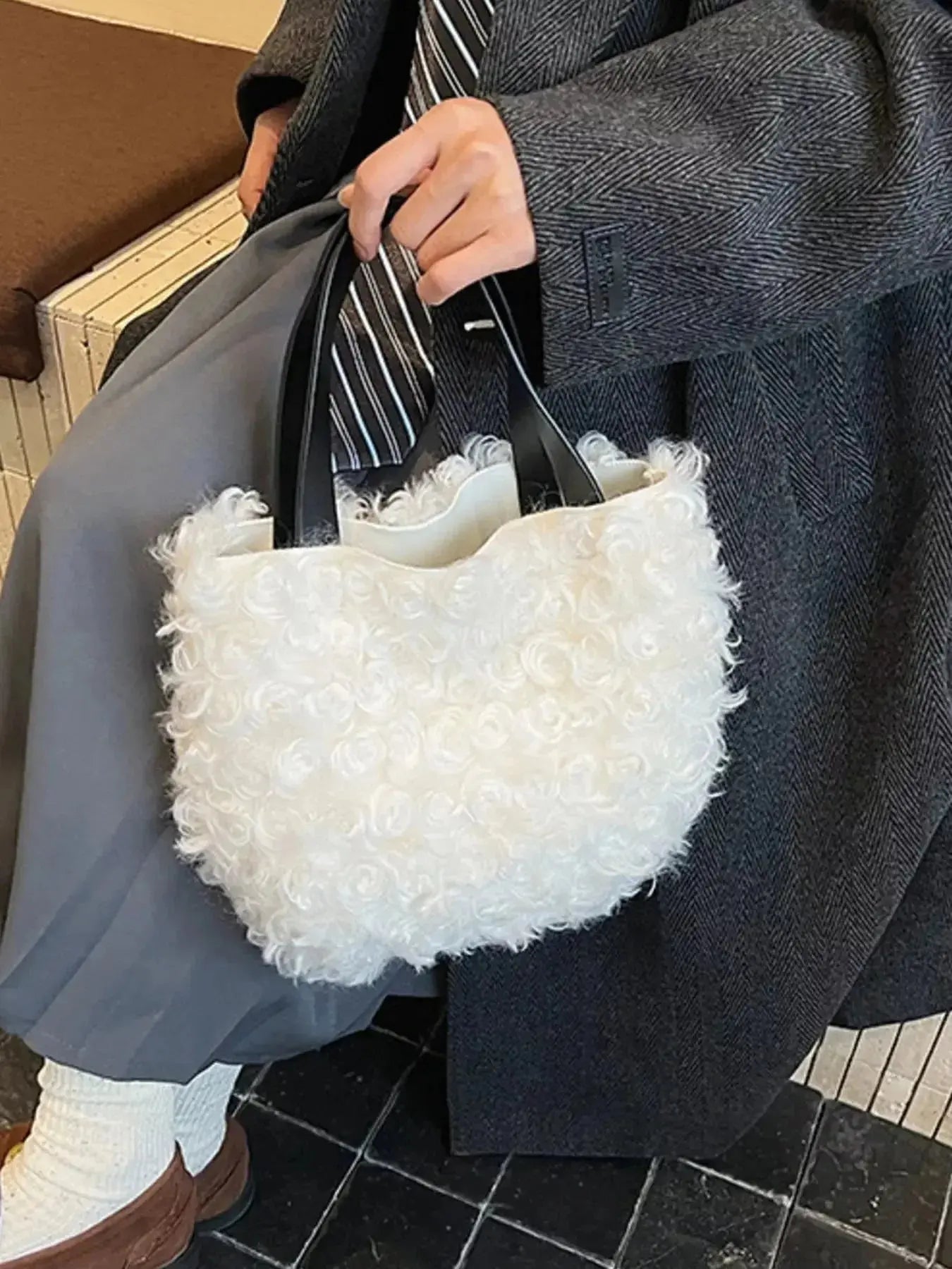 Lightweight fluffy plush shoulder bag with soft faux fur, trendy handbag by Trendsi featuring a cozy, stylish design.