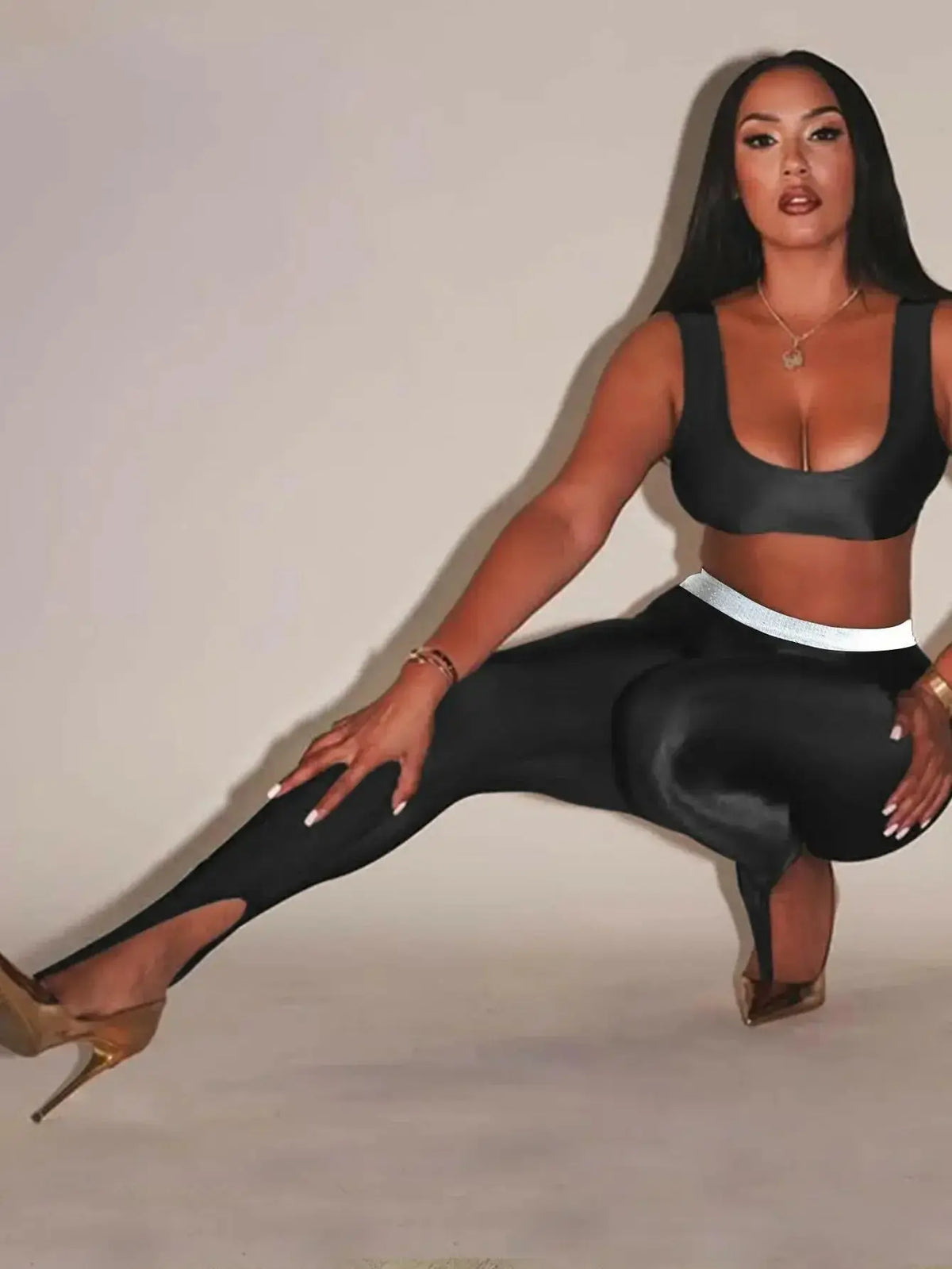 Front view of Plush Fashion Hub shiny, high-gloss stretch leggings with a sleek, fitted design on model's legs.