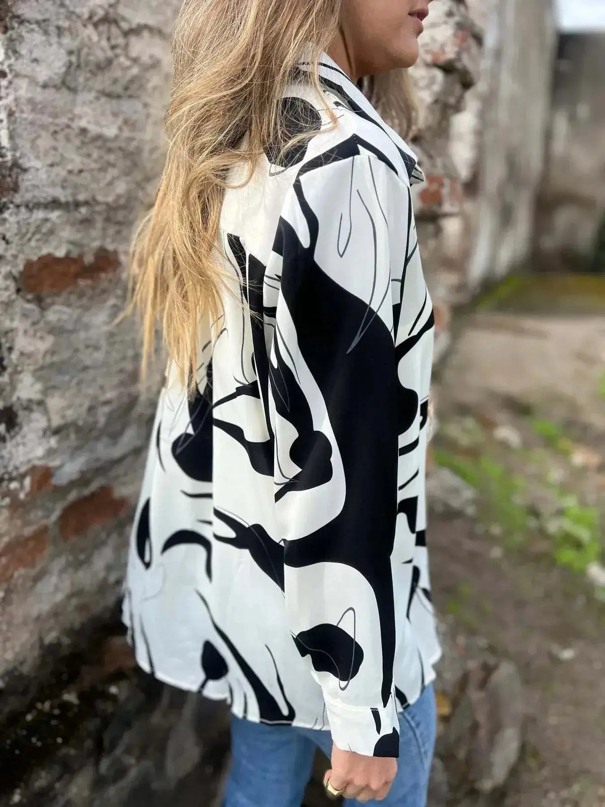 Plus size women's long sleeve button-up shirt with an abstract print from Plush Fashion Hub, featuring a stylish and comfortable fit.