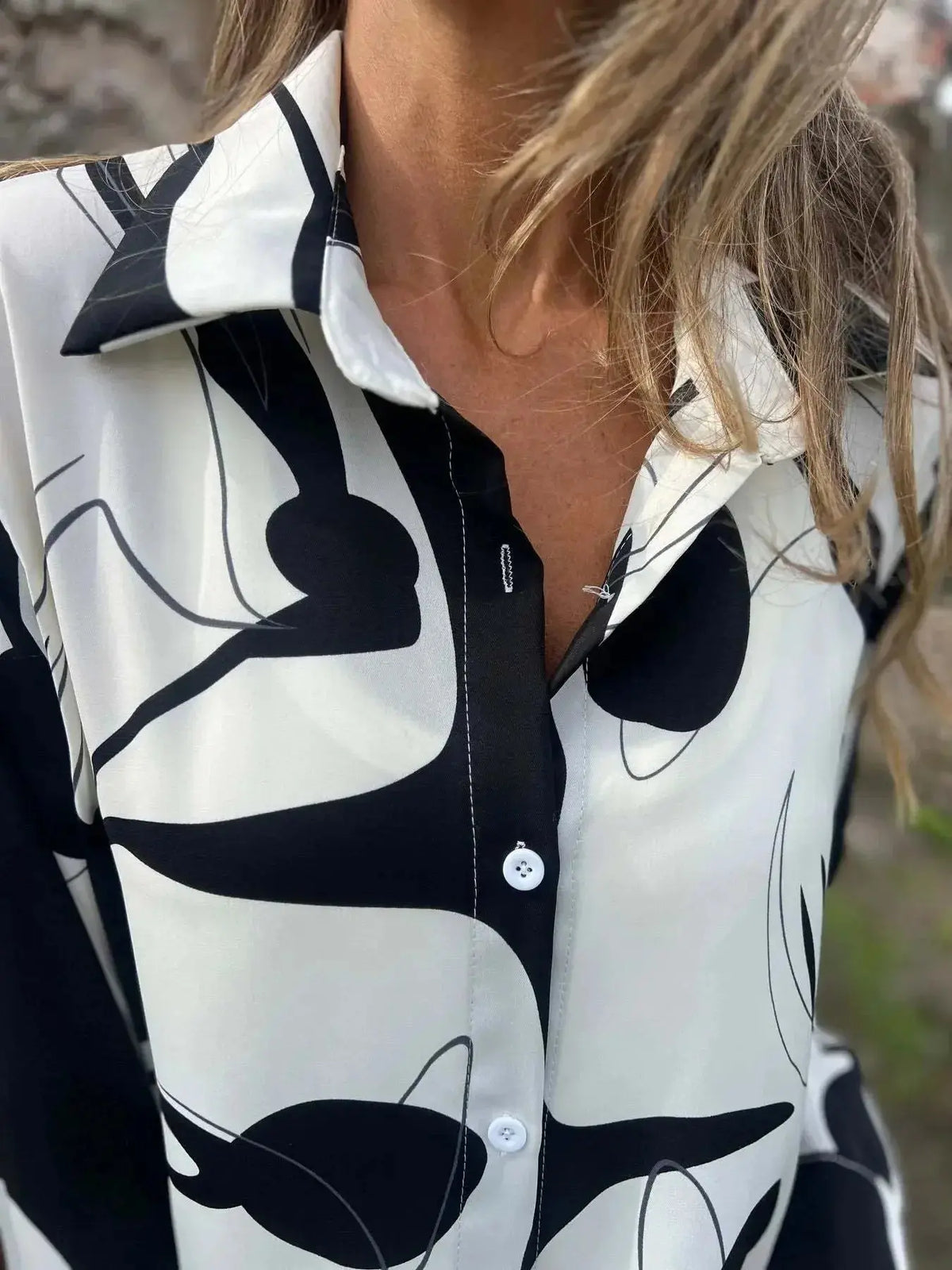 Plus size women's long sleeve button-up shirt with a colorful abstract print from Plush Fashion Hub.