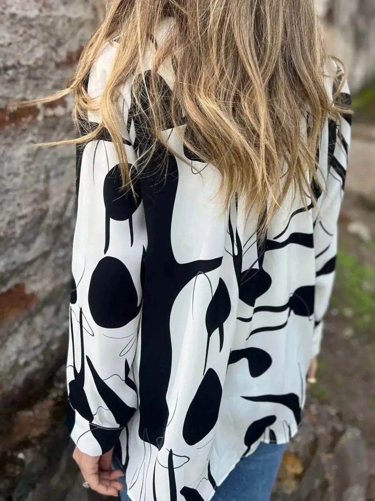 Plus size women's abstract print long sleeve button-up shirt by Plush Fashion Hub, shown in a full-length view.