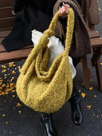 Fuzzy solid color crossbody bag from Plush Fashion Hub with plush fabric and adjustable strap, stylish and soft for everyday use.