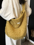 Fuzzy solid color crossbody bag by Plush Fashion Hub, soft plush material with a sleek strap and minimalist design.