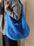 Fuzzy solid color crossbody bag by Plush Fashion Hub featuring plush material and simple design for casual wear.