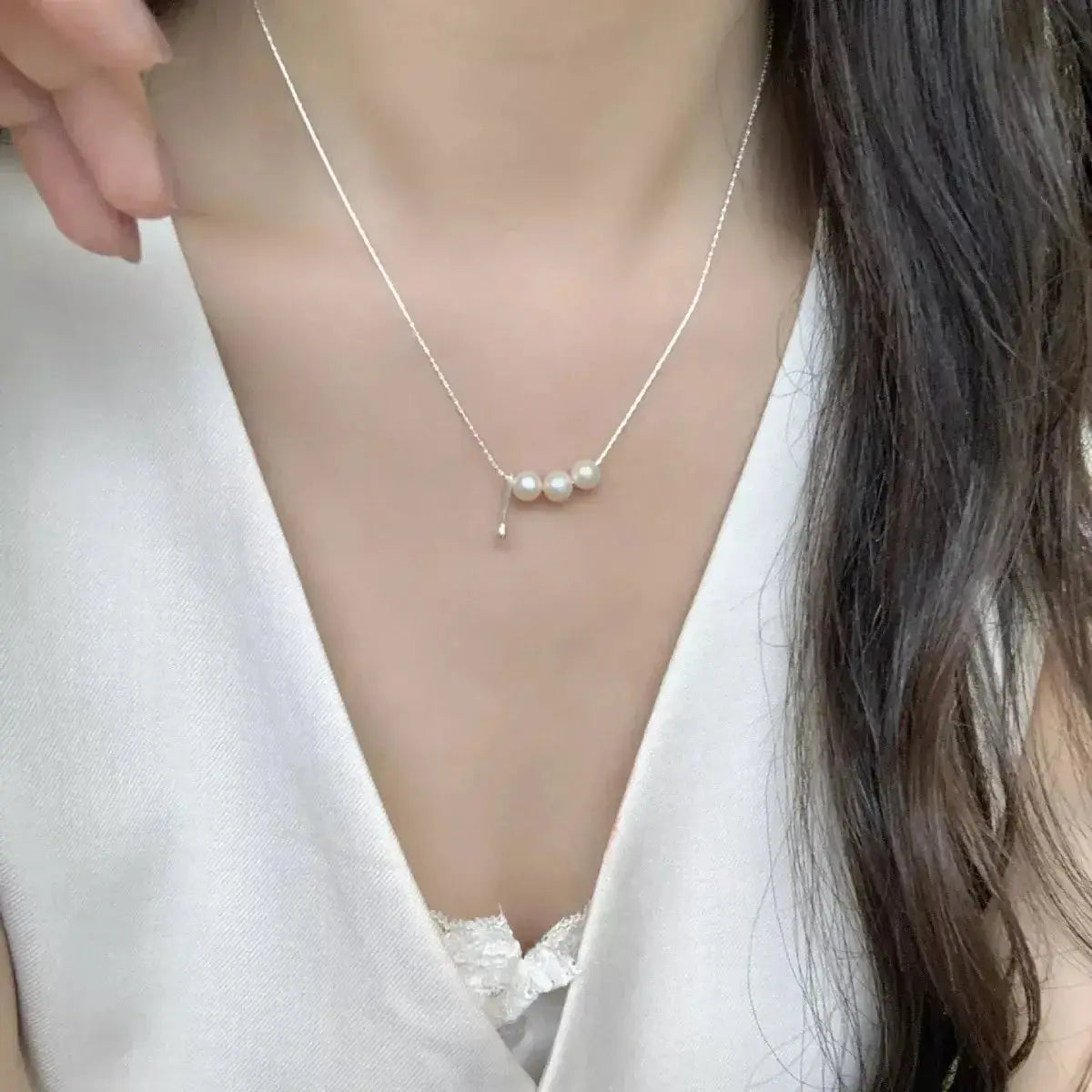 Freshwater pearl and sterling silver pendant necklace, elegant jewelry piece with a polished silver setting and lustrous pearl.