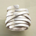 Silver-tone geometric winding hoop ring with modern design, crafted by Plush Fashion Hub, displayed on a neutral background.