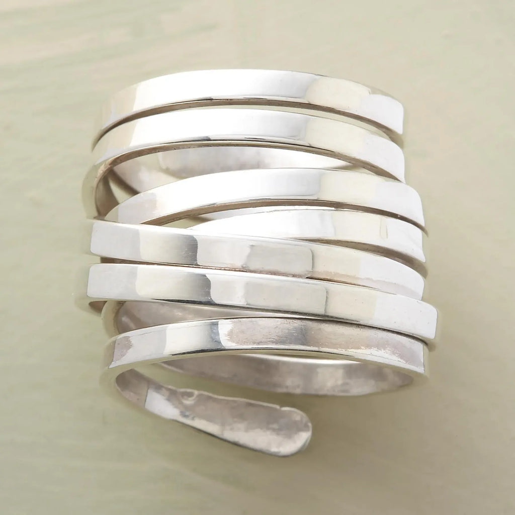 Silver-tone geometric winding hoop ring with modern design, crafted by Plush Fashion Hub, showcasing a bold jewelry statement piece.