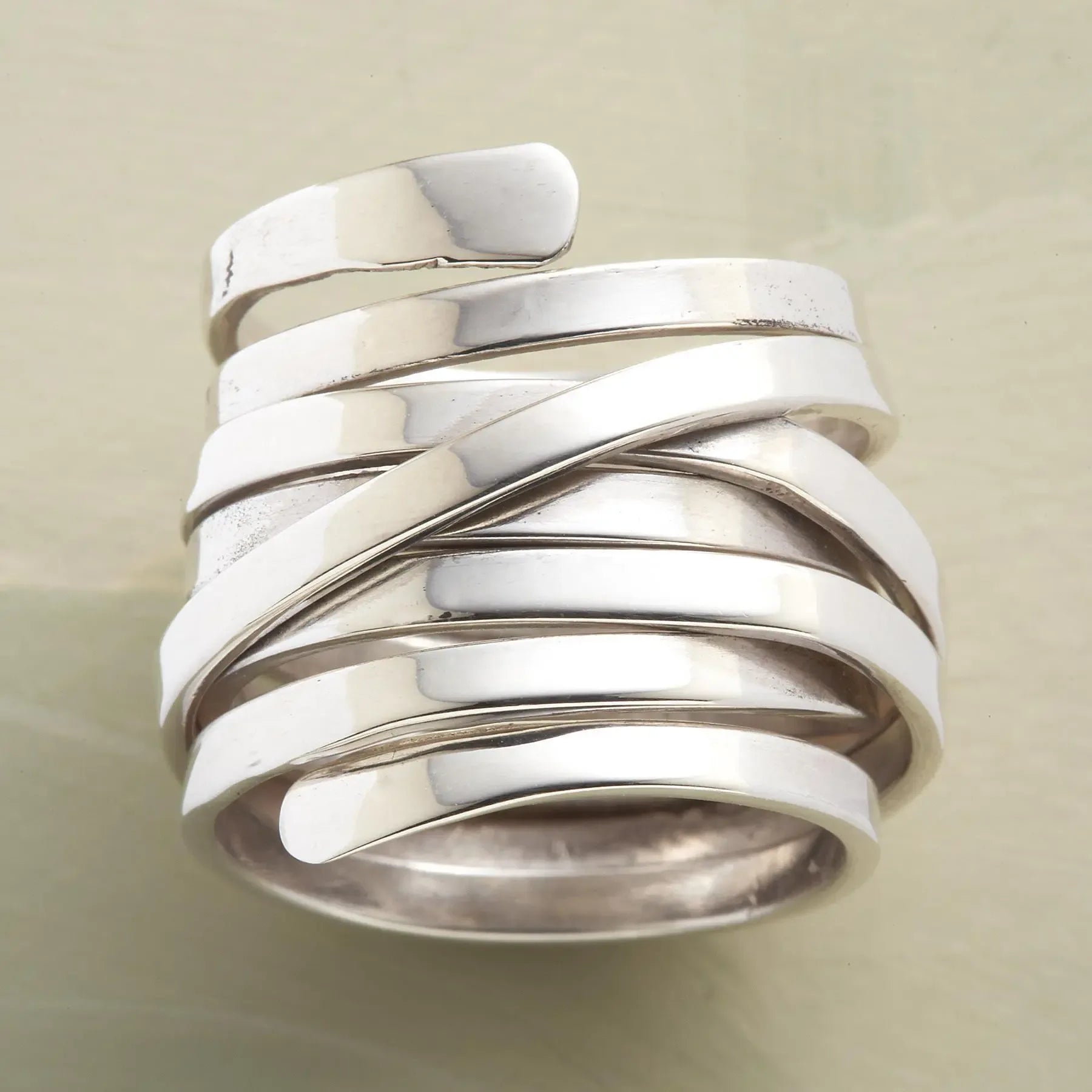 Silver-tone geometric winding hoop ring with modern design, crafted by Plush Fashion Hub, showcasing contemporary jewelry style.