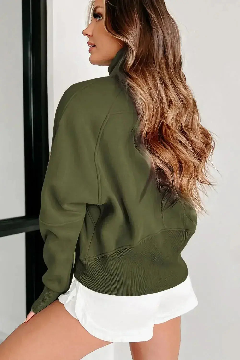 Women's green ribbed zip stand-collar sweatshirt with thumbhole sleeves from Plush Fashion Hub, casual and comfortable for everyday wear.