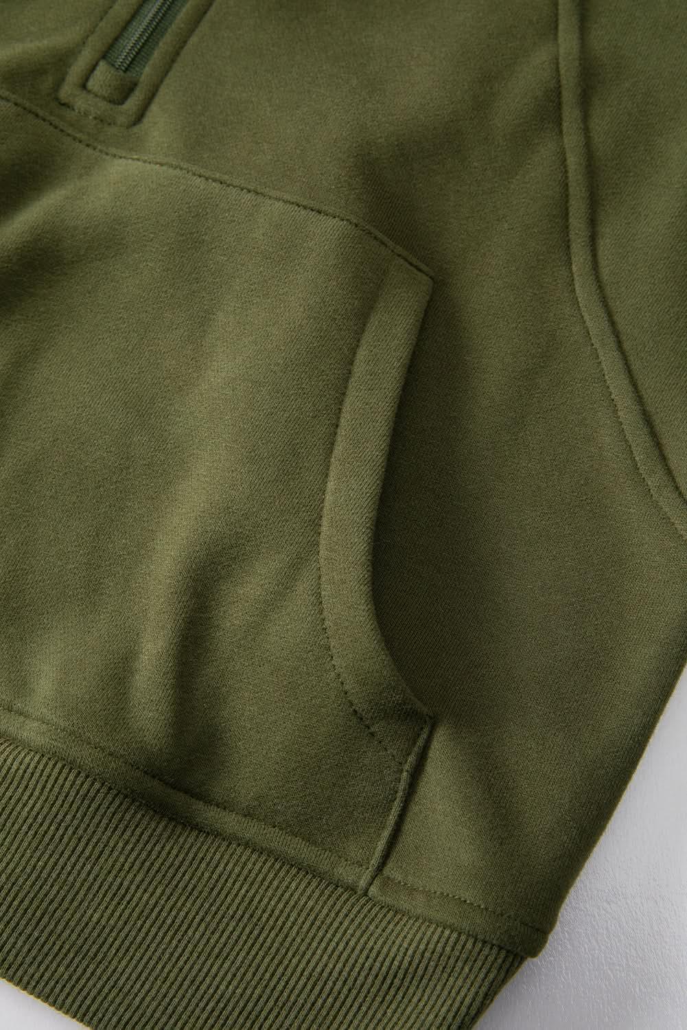 Women's green ribbed zip-up sweatshirt with stand collar and thumbhole sleeves from Plush Fashion Hub.