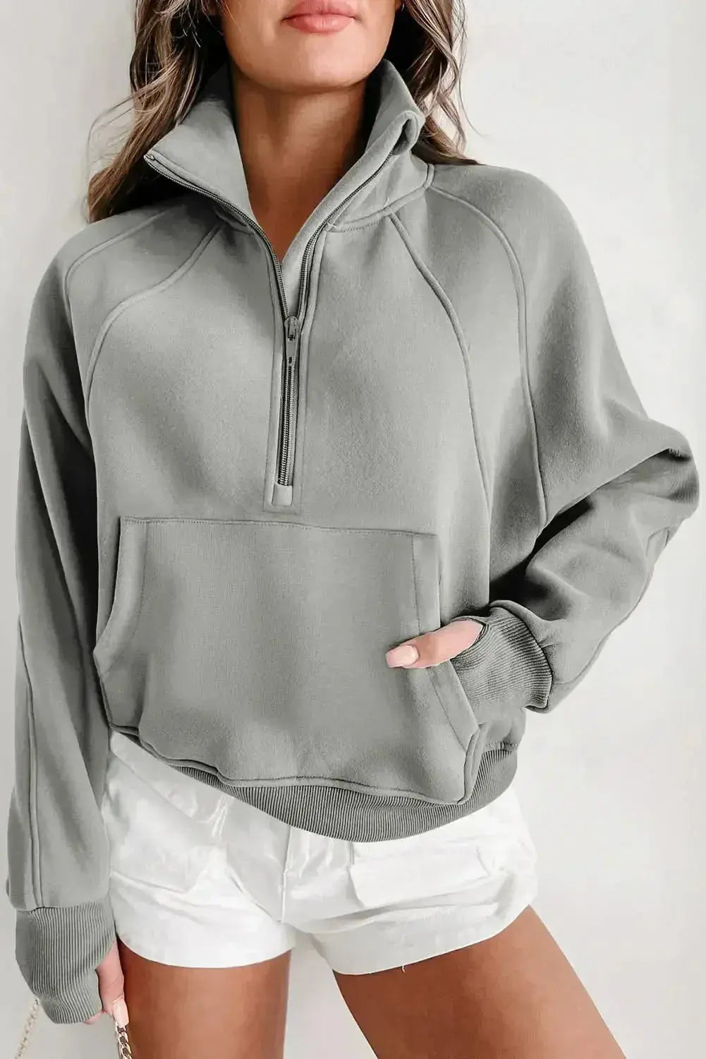 Women's green ribbed zip stand-collar sweatshirt with thumbhole sleeves from Plush Fashion Hub.