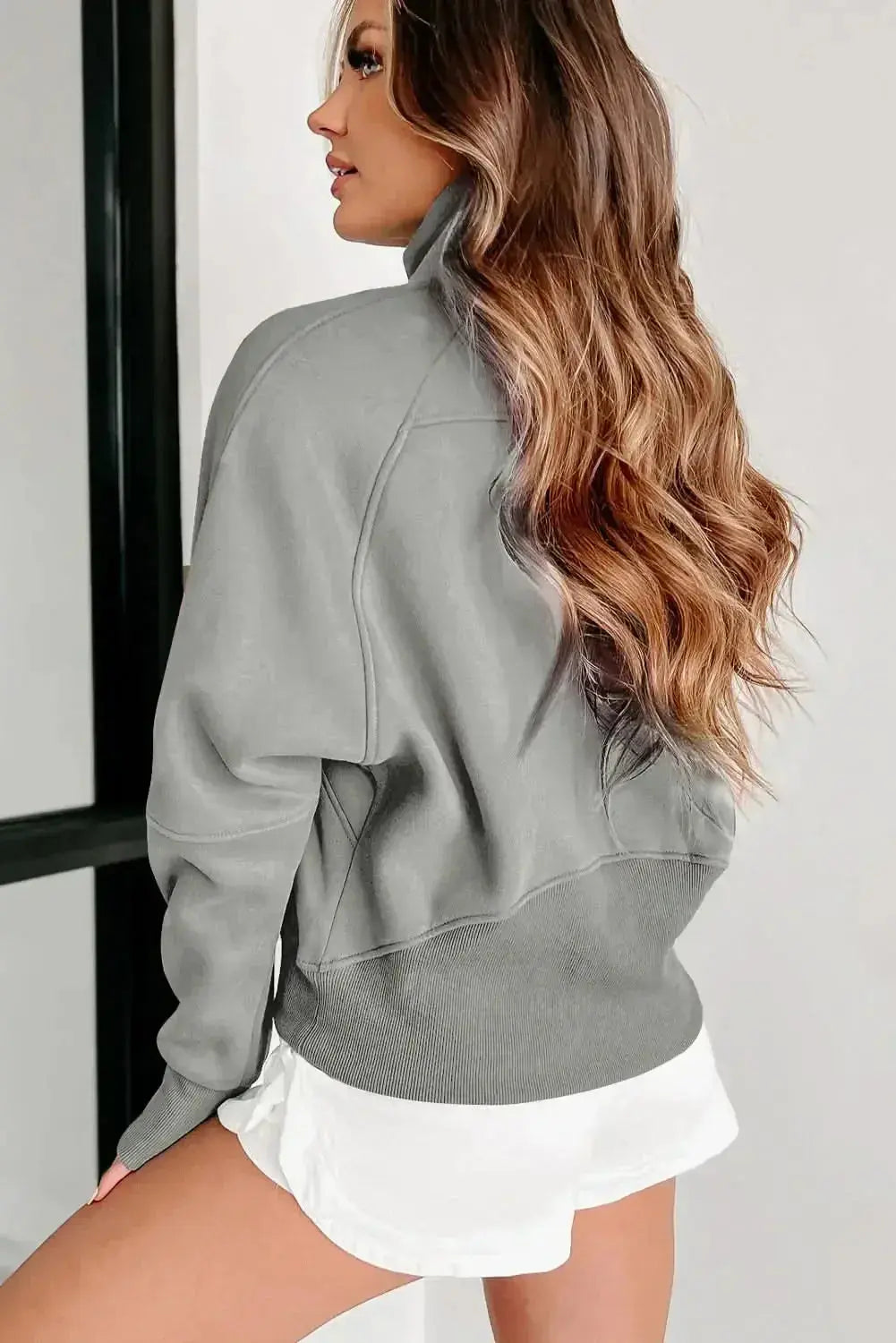 Women's green ribbed zip stand-collar sweatshirt with thumbhole sleeves, from Plush Fashion Hub.