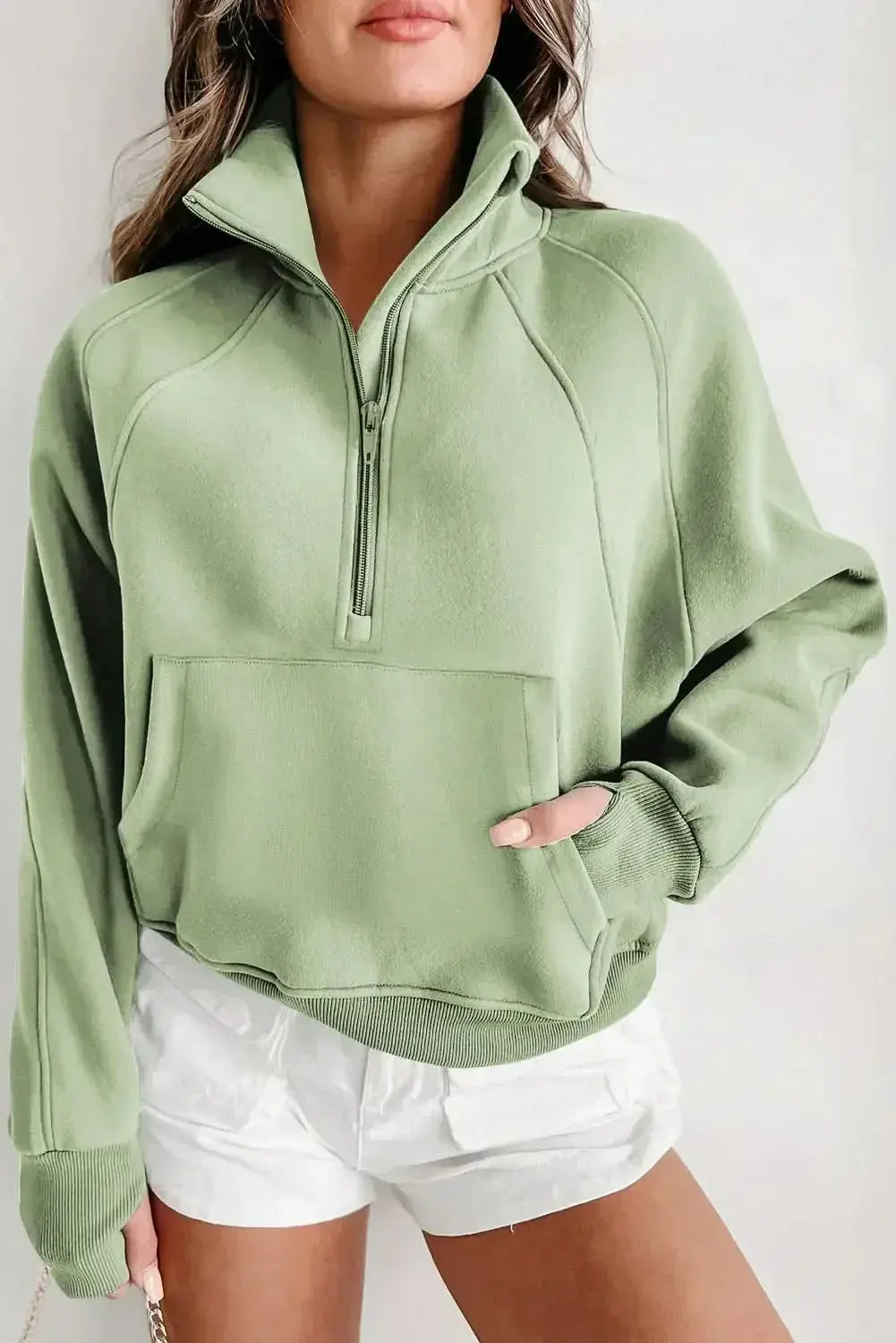 Women's green ribbed zip stand-collar sweatshirt with thumbhole sleeves, from Plush Fashion Hub, casual and comfortable sweatshirt.