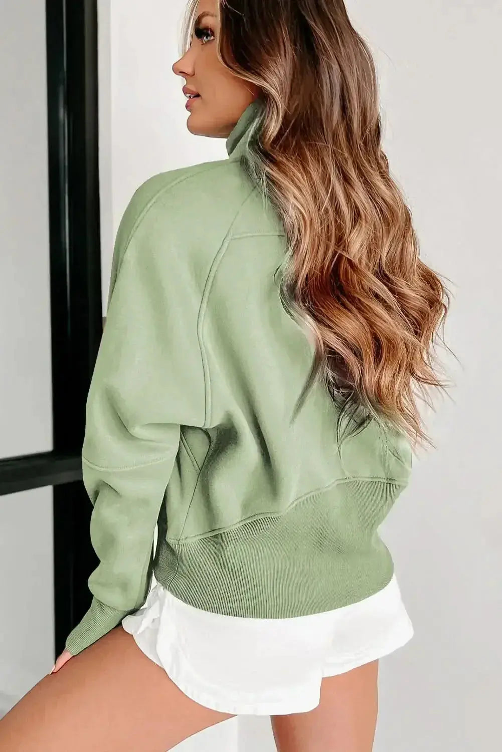 Women's green ribbed zip stand-collar sweatshirt with thumbhole sleeves from Plush Fashion Hub, casual and comfortable.