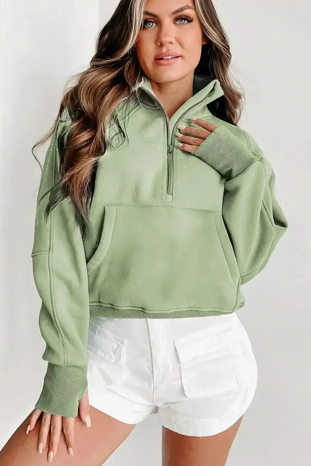 Women's green ribbed zip-up sweatshirt with stand collar and thumbhole sleeves from Plush Fashion Hub.