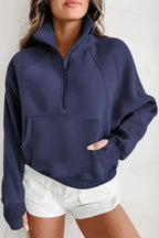 Women's green ribbed zip-up sweatshirt with stand collar and thumbhole sleeves, stylish and comfortable from Gilded Glamour Shop.