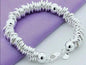 New Arrival 925 Silver Color Charm Cuff Bangle for Women on purple fabric.