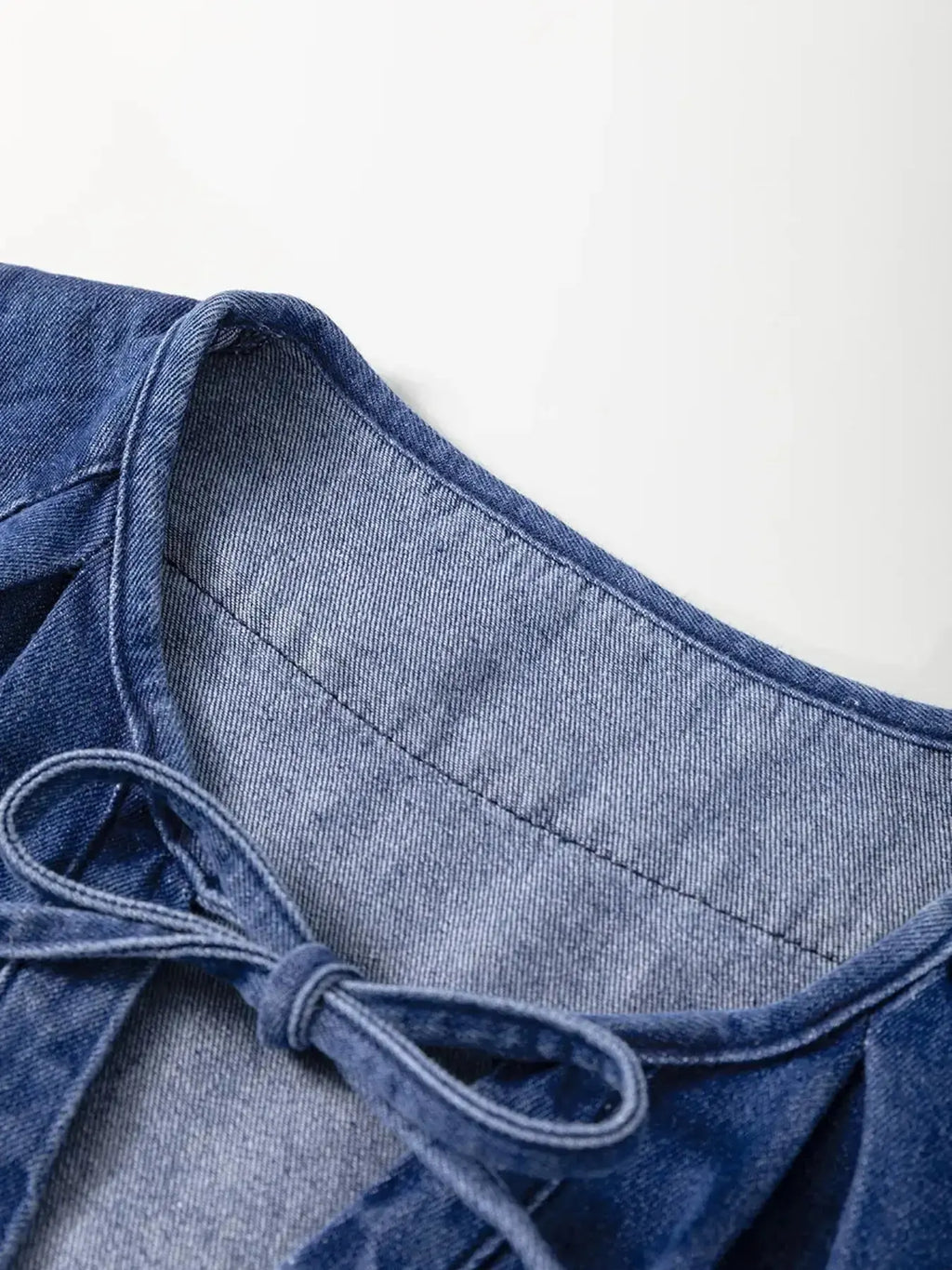 High-waist puff sleeve denim mini dress made from soft cotton blend, perfect for casual summer wear.