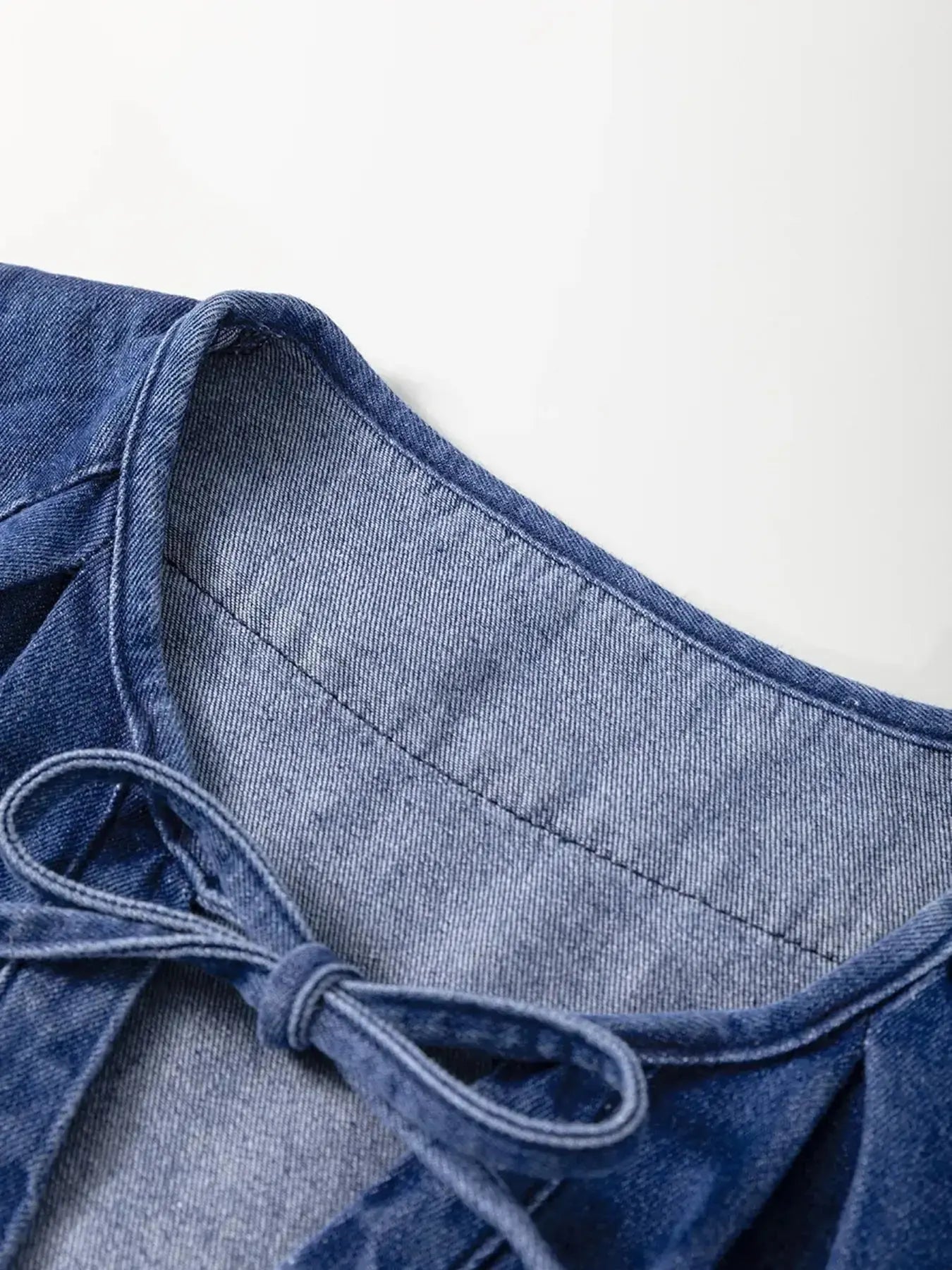 High-waist puff sleeve denim mini dress made from soft cotton blend, perfect for casual summer wear.