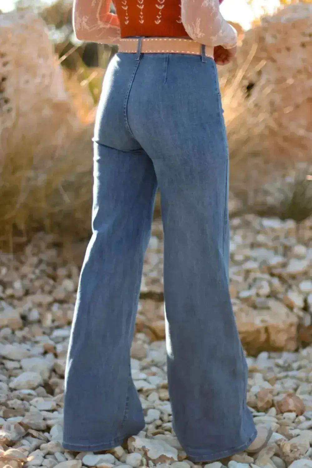 High-waisted wide-leg denim jeans with button front by Trendsi, featuring classic blue wash and relaxed fit.
