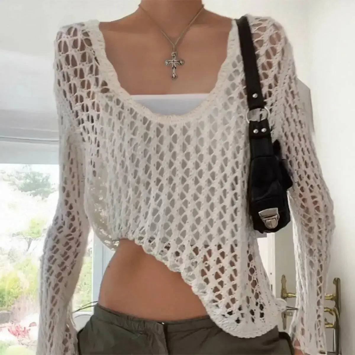 Women's hollow-out long sleeve casual lightweight pullover top by Plush Fashion Hub, featuring a modern, stylish design.
