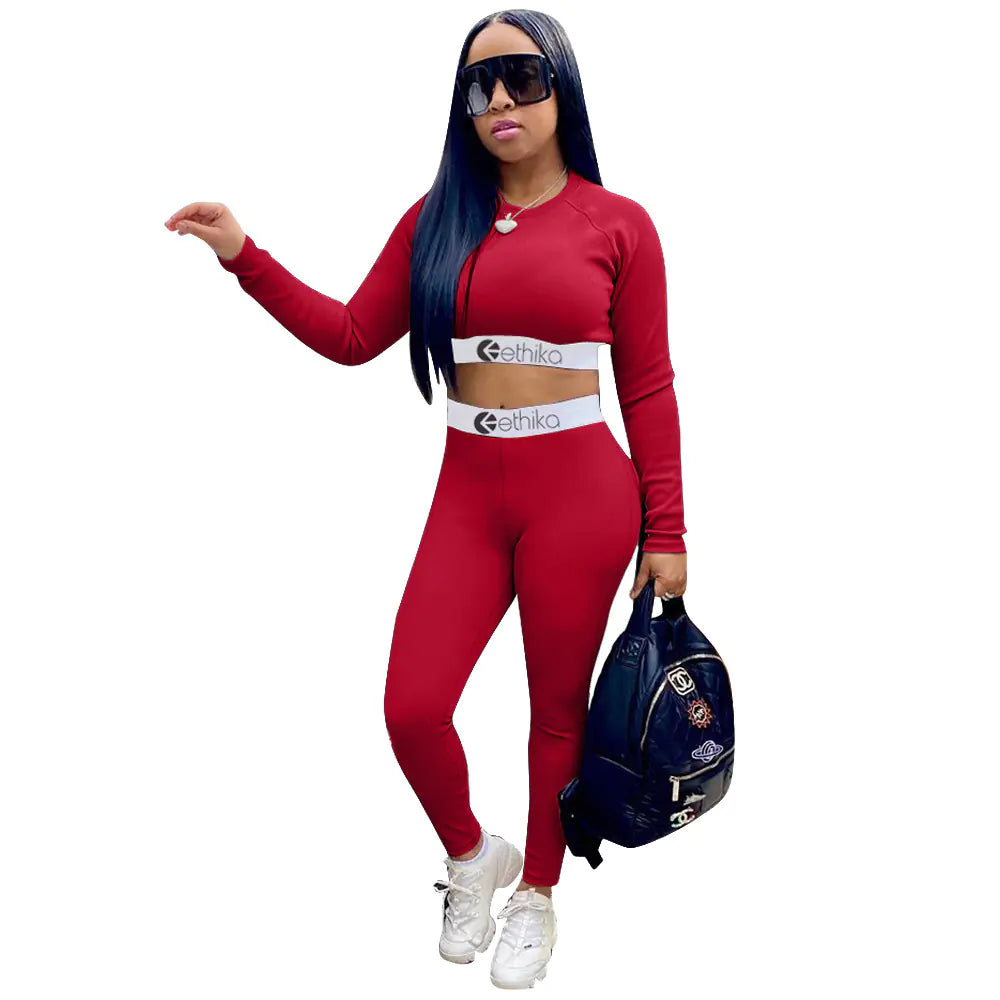 Women's two-piece sports set with letter print, featuring a fitted top and matching shorts for active wear by Trendy Attic Store01.