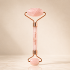 Rose quartz facial roller device by Timeless Organics Skin Care, showing a pink stone roller used for facial massage and skincare.