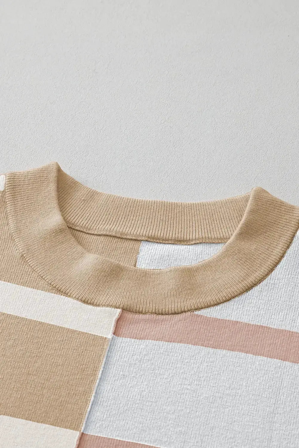 Colorblock oversized sweater by Threaded Pear featuring stripe patterns in various colors, displayed on a neutral background.