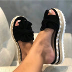 Women’s bow sandals with platform wedge heel featuring stylish design and comfortable straps, perfect for summer wear.