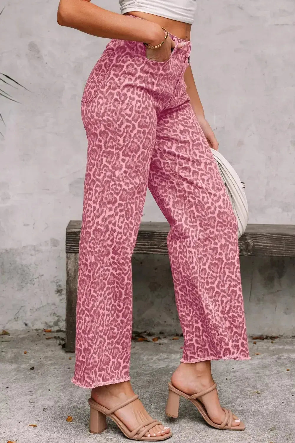 Leopard print high-waisted wide-leg jeans with frayed hem by Trendsi, showcasing stylish, relaxed-fit denim with bold animal print.