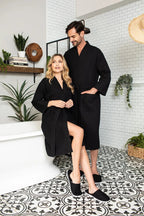 Knee-length waffle robe for women in soft, breathable fabric by Lotus Linen, hanging on a wooden hook for display.