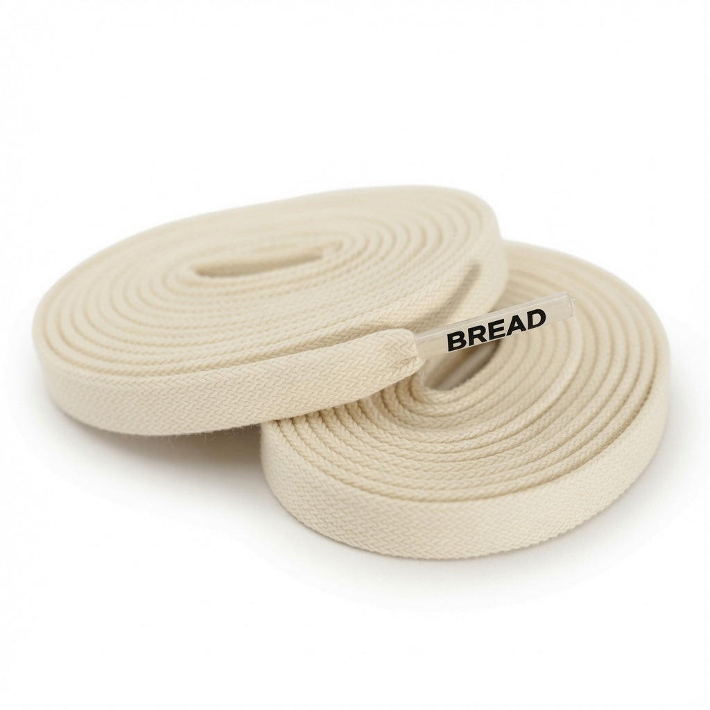 Elastic shoelaces in Luxe Creme color by Bread, featuring a sleek, smooth design perfect for comfortable, stylish footwear.