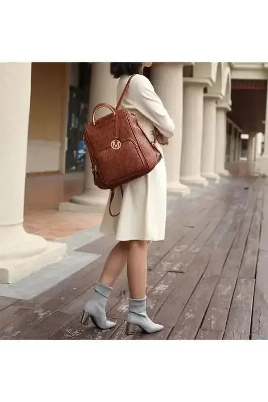 Gilded Glamour Shop Mia Signature vegan leather backpack with gold-tone hardware, trendy design, and sleek silhouette.