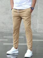Men's slim fit casual drawstring trousers with pockets, lightweight pants from Plush Fashion Hub, suitable for everyday wear.