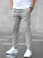 Men's slim fit casual drawstring trousers from Plush Fashion Hub, lightweight pants with side pockets and a modern fit.