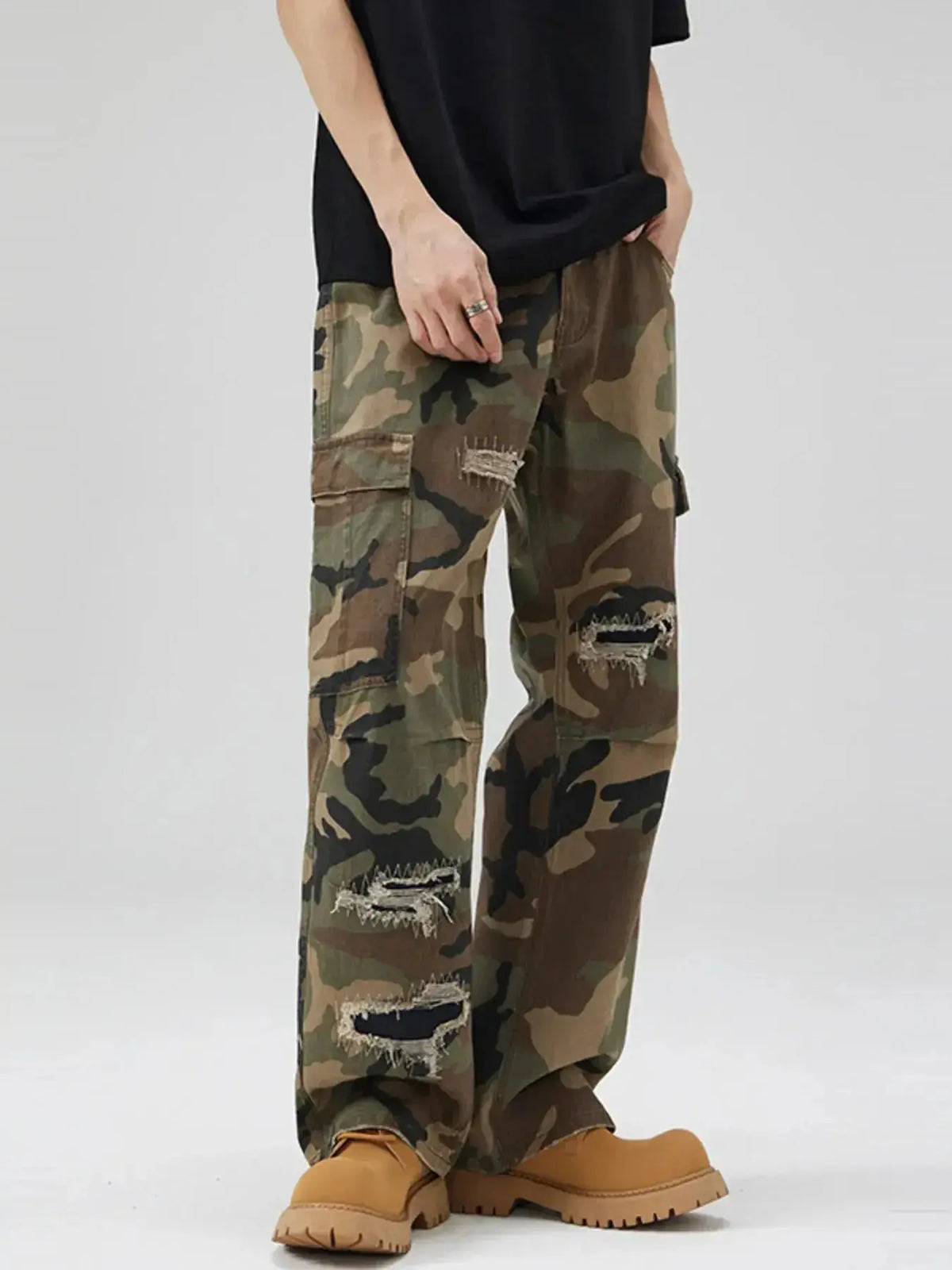 Men's distressed camouflage cargo pants in rugged cotton with streetwear style, featuring utility pockets and a rugged look.