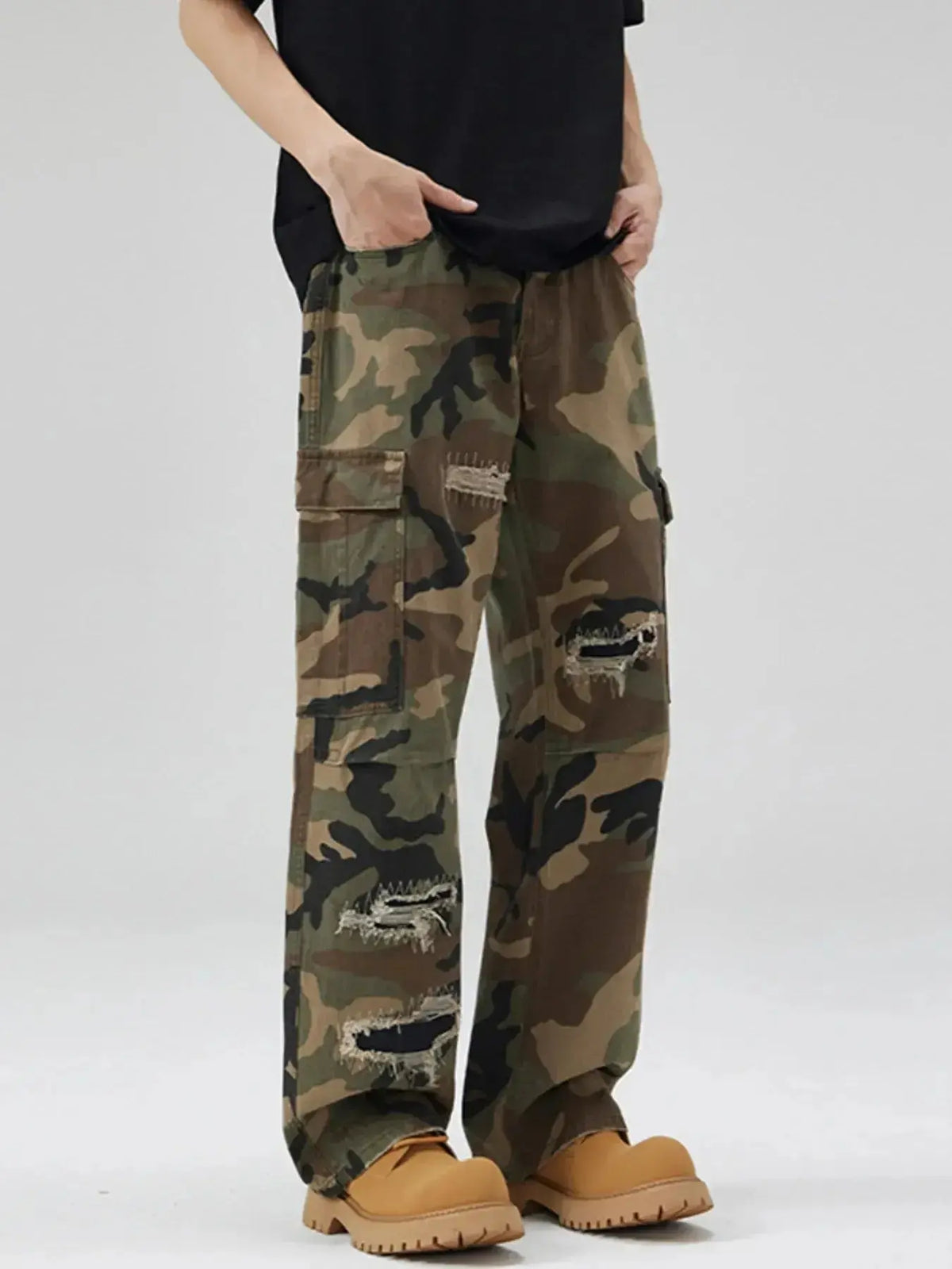 Men's distressed camouflage cargo pants by Plush Fashion Hub, rugged cotton streetwear with utility design and distressed details.