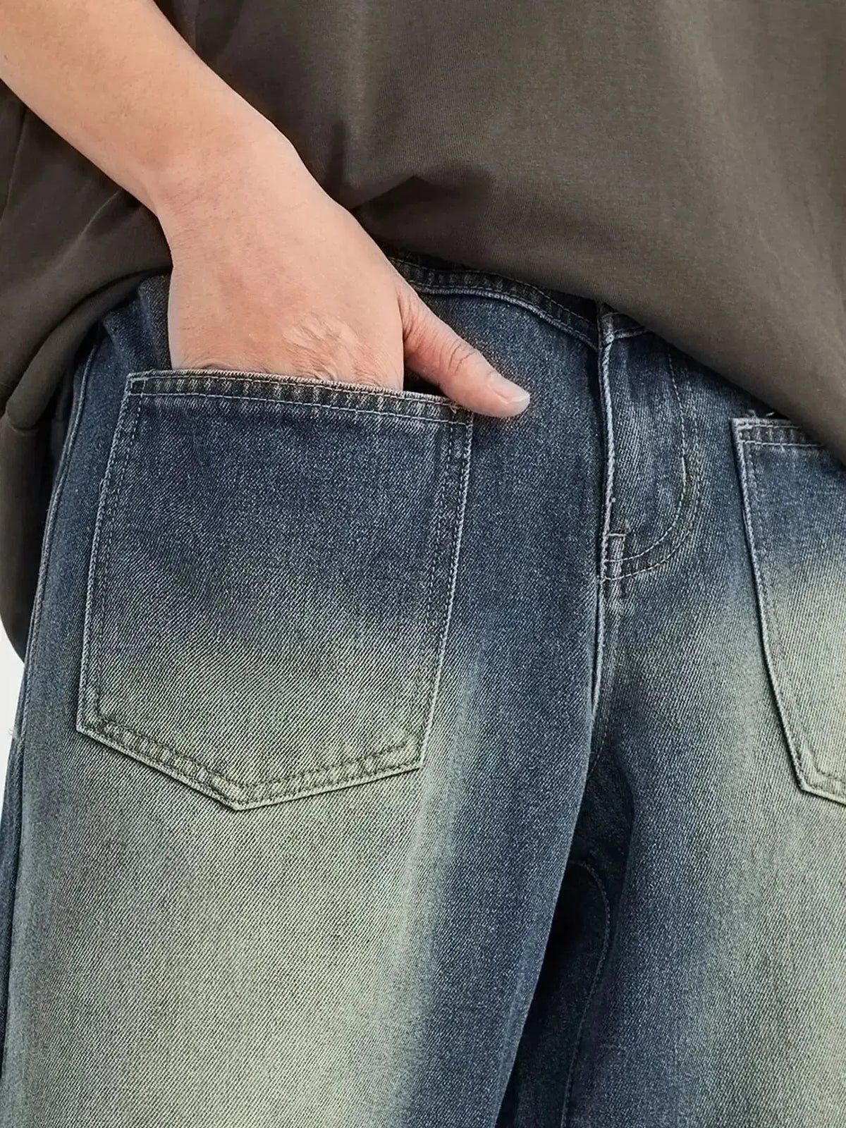 Men's vintage wash wide-leg denim jeans by Plush Fashion Hub with relaxed fit and cotton fabric, shown on a model.