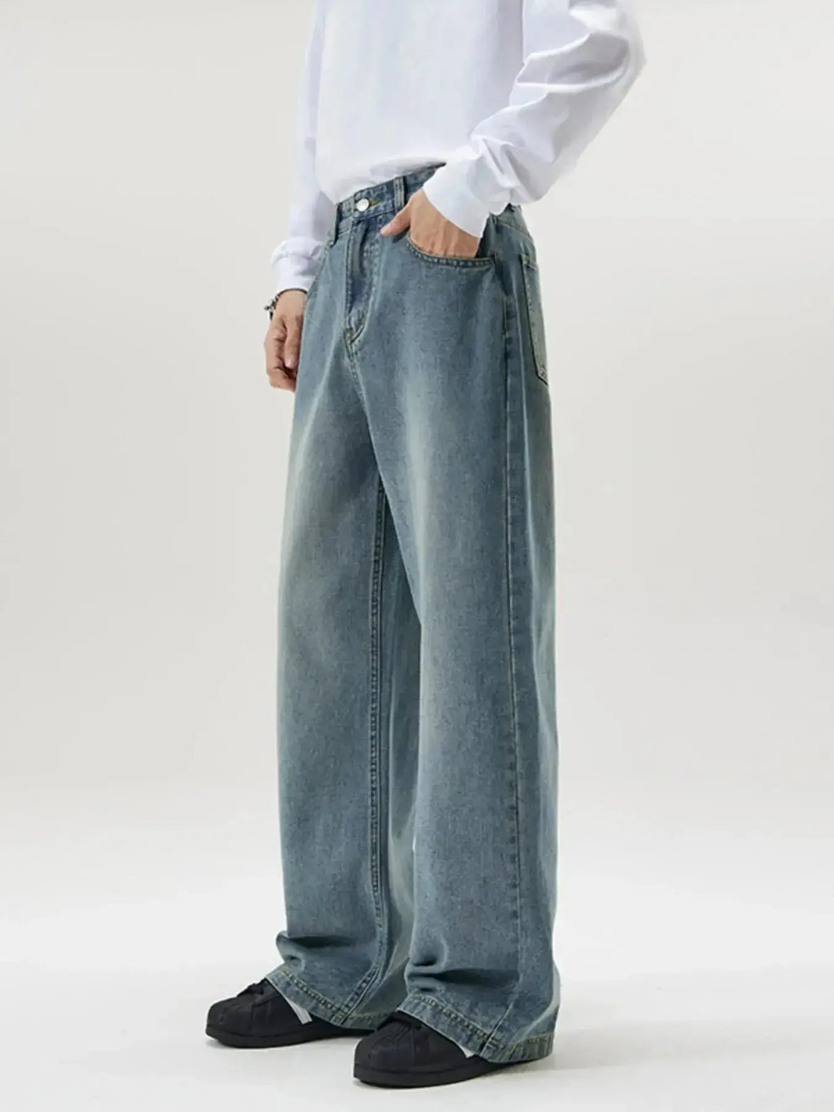 Men's vintage wash wide-leg jeans by Plush Fashion Hub with relaxed fit and retro denim style, shown on a model.