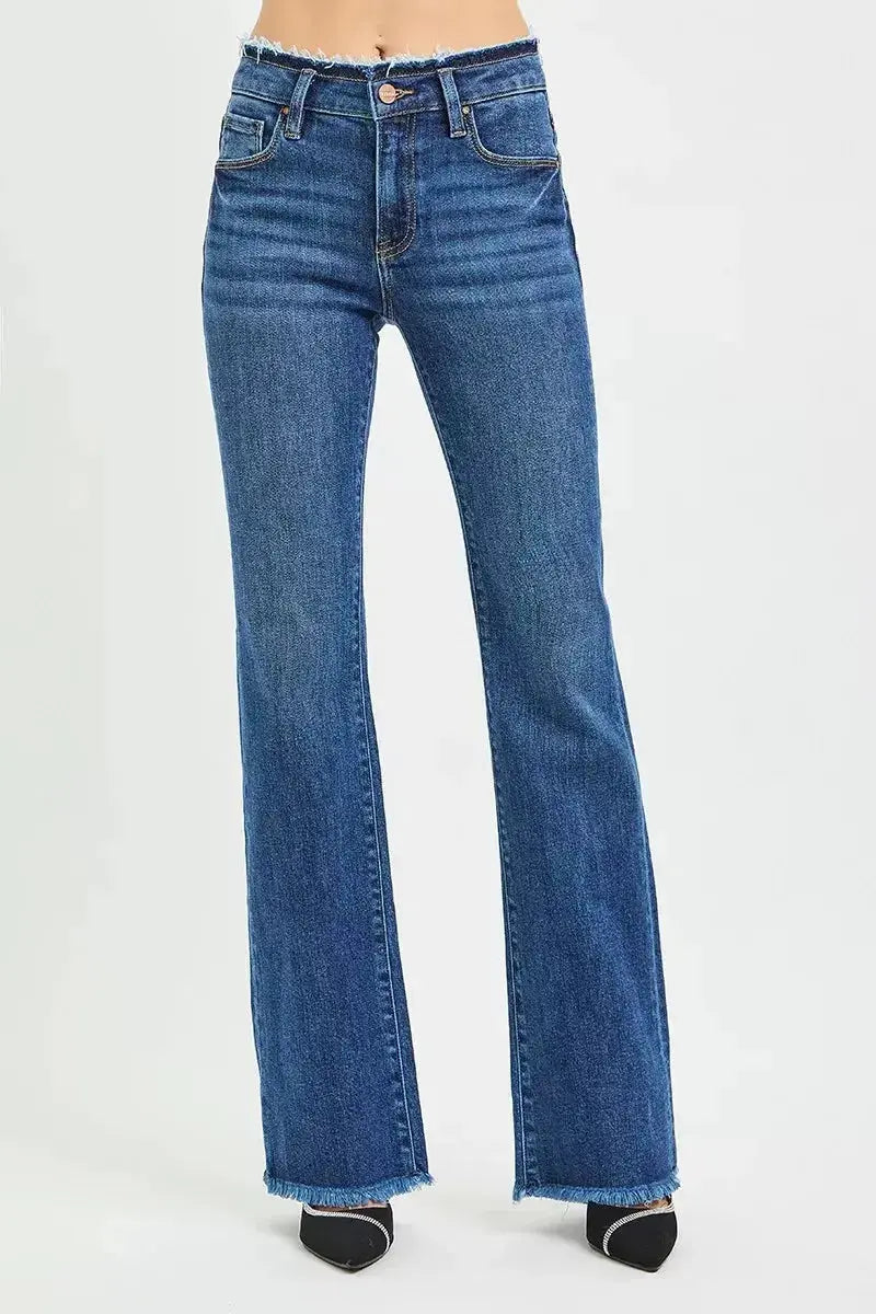 Plush Fashion Hub mid-rise bootcut jeans with frayed waist and raw hem, showcasing trendy denim style and distressed details.