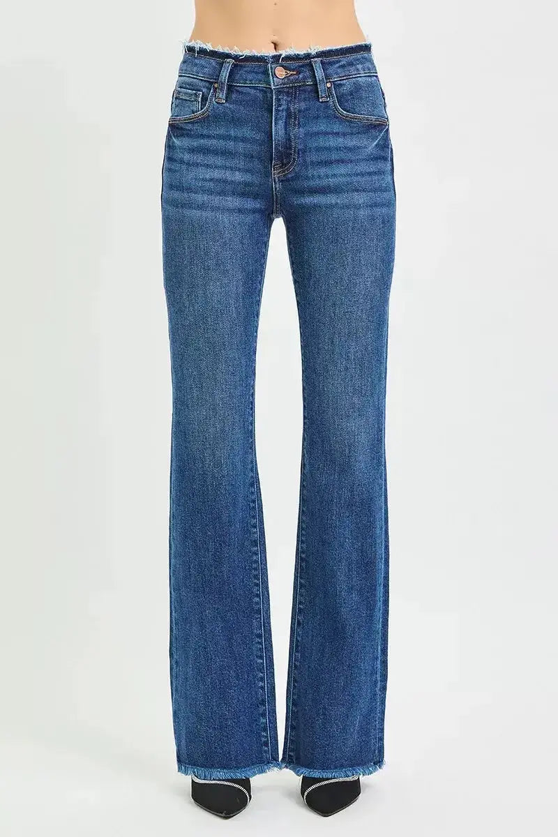 Plush Fashion Hub mid-rise bootcut jeans with frayed waist and raw hem, showcasing trendy denim style and distressed details.