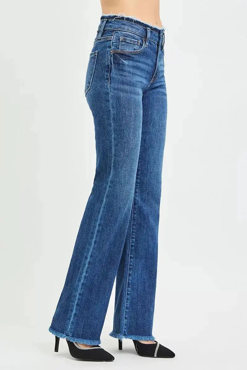 Plush Fashion Hub mid-rise bootcut jeans with frayed waist and raw hem, showcasing trendy distressed denim style.