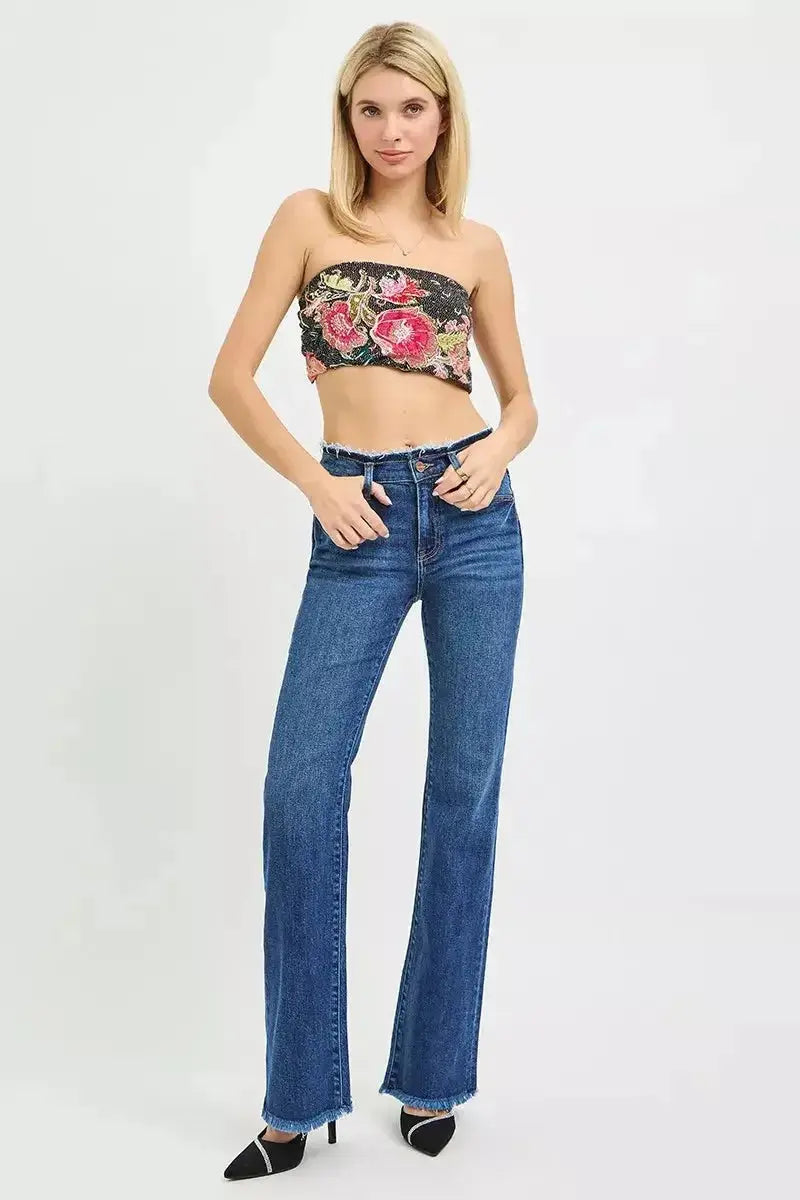 Mid-rise bootcut jeans with frayed waist and raw hem detail from Plush Fashion Hub, showcased on a model.