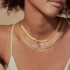 Minimalist gold cross pendant necklace with dainty chain, unisex design, layered style, from Plush Fashion Hub.