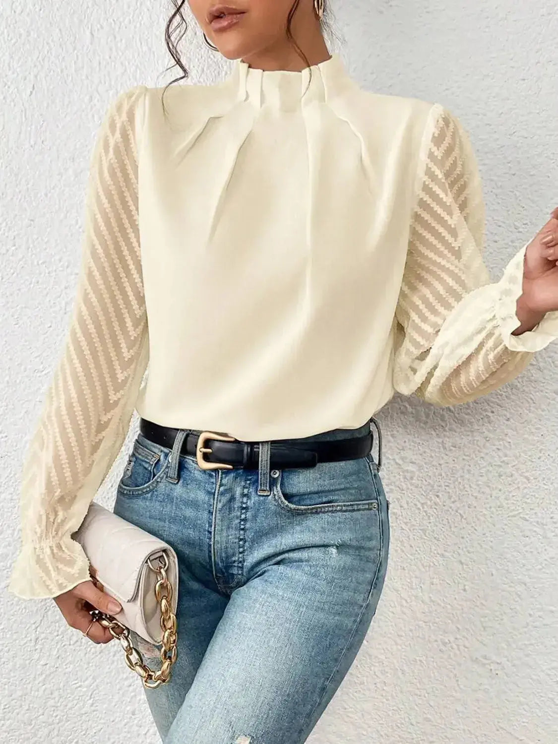Elegant plush fashion hub mock neck blouse with flounce sleeves, shown on a model, featuring a stylish and sophisticated design.