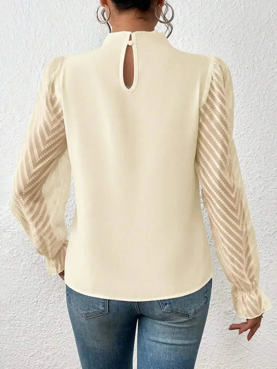 Elegant black mock neck blouse with flounce sleeves from Plush Fashion Hub, shown on a hanger.