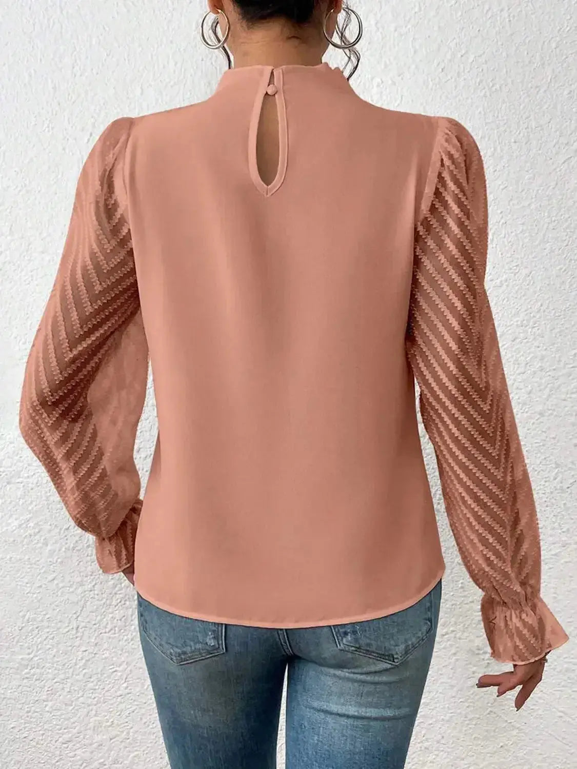Elegant plush fashion hub mock neck blouse with flounce sleeves, shown in a stylish, close-up shot of the shirt's neckline and sleeves.